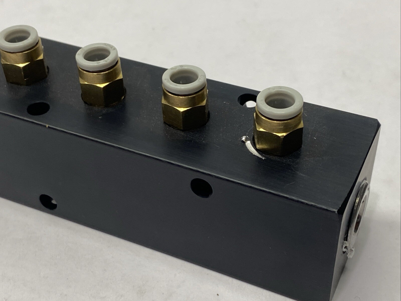 Polyconn PCM20-125-04B Pneumatic Manifold 4x 1/8" NPT Out 3/8" NPT In - Maverick Industrial Sales